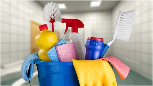 Person treating a fresh spill on fabric with stain removal solution